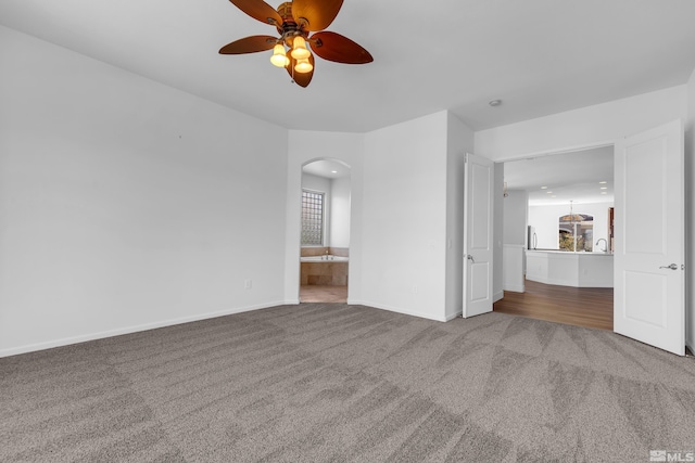 empty room featuring carpet flooring and ceiling fan