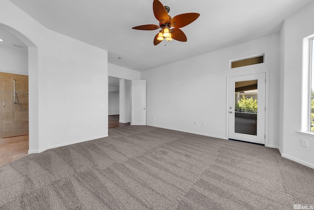 spare room with ceiling fan and carpet