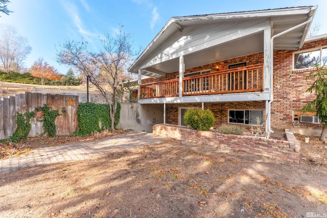 rear view of property featuring a balcony