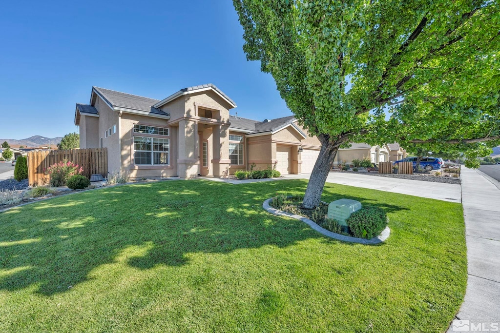 view of front facade featuring a front yard and a garage