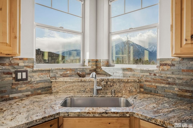 kitchen featuring a mountain view, sink, and a healthy amount of sunlight