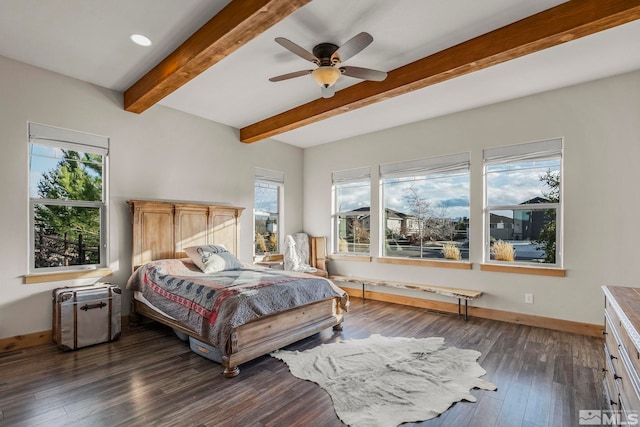 bedroom with beamed ceiling, multiple windows, dark wood-type flooring, and ceiling fan