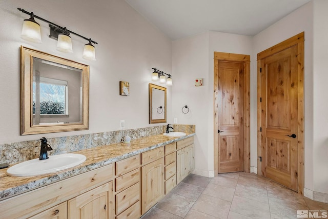 bathroom with tile patterned flooring and vanity