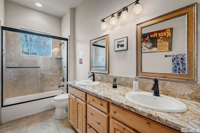 full bathroom with tile patterned flooring, vanity, enclosed tub / shower combo, and toilet