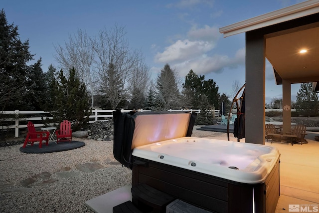 yard at dusk with a patio area and a hot tub