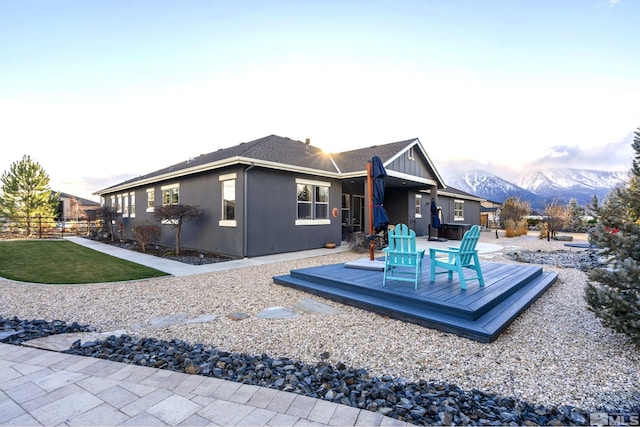 back of property featuring a deck with mountain view