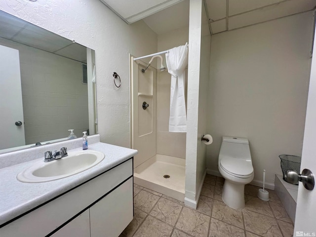 bathroom featuring vanity, toilet, and walk in shower