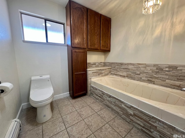 bathroom featuring tiled bath, toilet, a baseboard heating unit, and a notable chandelier