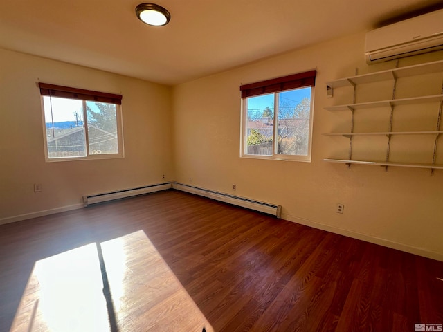 unfurnished room featuring a healthy amount of sunlight, dark hardwood / wood-style flooring, and an AC wall unit