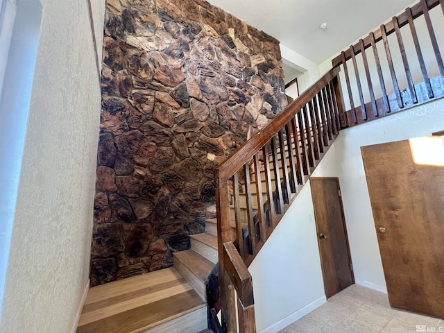 stairway featuring tile patterned floors