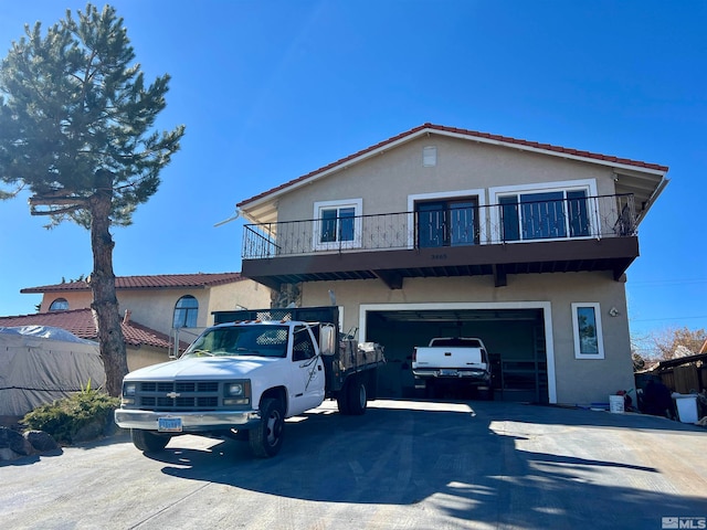 view of front of home with a garage and a balcony