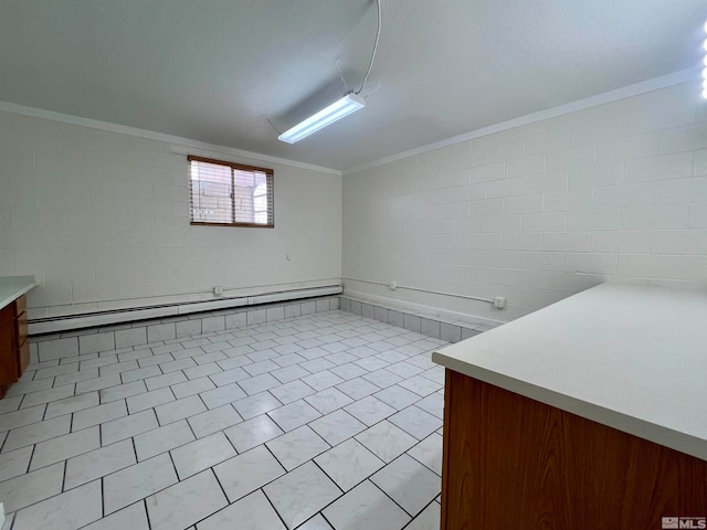 basement with a baseboard radiator and crown molding