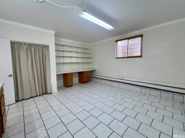 basement featuring built in desk, ornamental molding, and a baseboard radiator