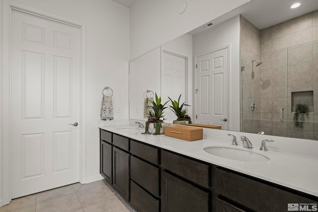 bathroom featuring tile patterned flooring, vanity, and an enclosed shower