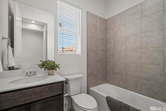 full bathroom with vanity, toilet, and tiled shower / bath