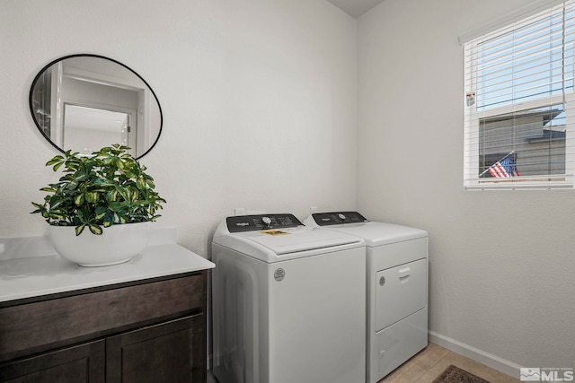 laundry area featuring washer and dryer and cabinets