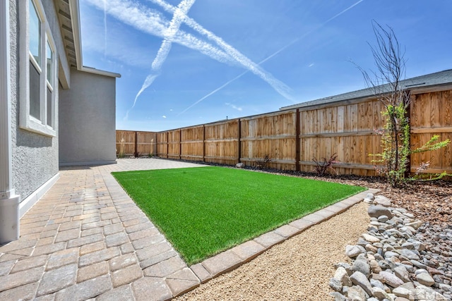 view of yard featuring a patio area and a fenced backyard