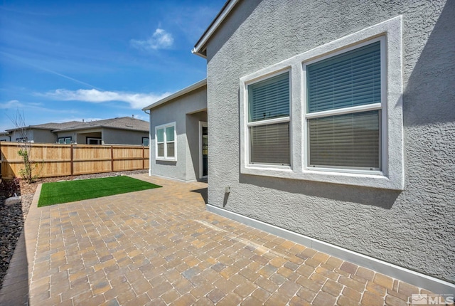 view of patio featuring fence