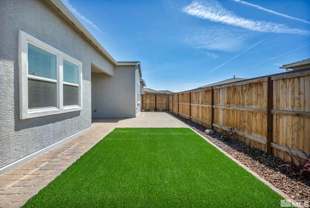 view of yard with a fenced backyard and a patio area