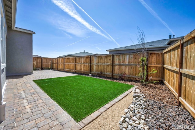 view of yard featuring a patio and a fenced backyard