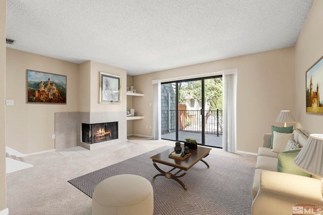 living room featuring a tile fireplace, light carpet, and a textured ceiling