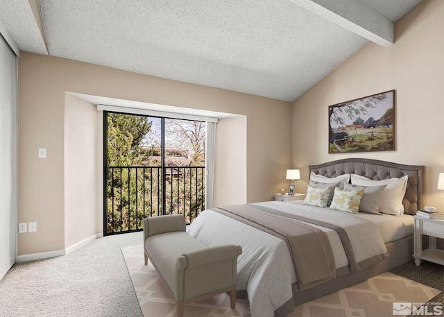 carpeted bedroom with a textured ceiling, lofted ceiling with beams, and access to outside