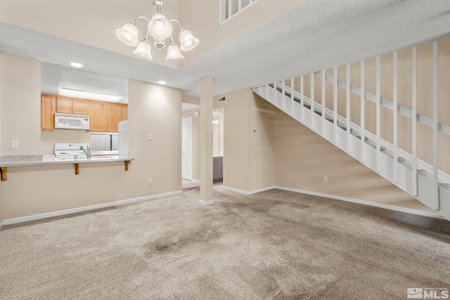 unfurnished living room with sink, light colored carpet, a textured ceiling, and an inviting chandelier