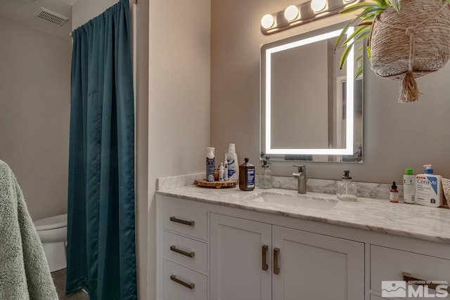 bathroom featuring vanity and toilet