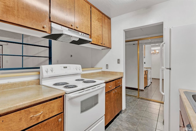 kitchen featuring light tile patterned floors and white appliances