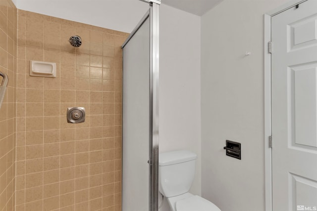 bathroom featuring toilet and walk in shower