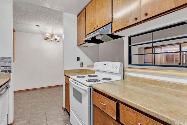 kitchen featuring a textured ceiling, light tile patterned floors, a chandelier, and white appliances