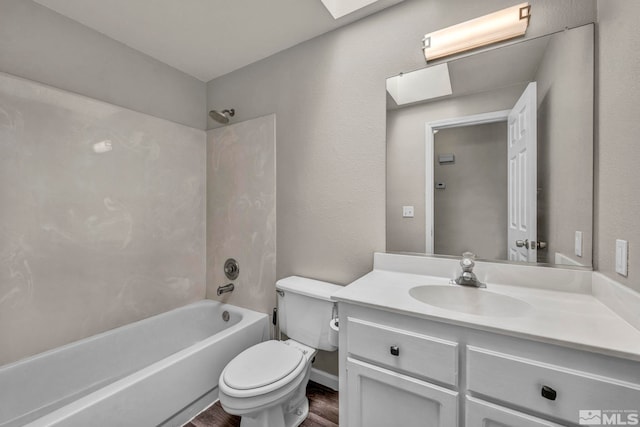 full bathroom with a skylight, shower / bath combination, wood-type flooring, toilet, and vanity