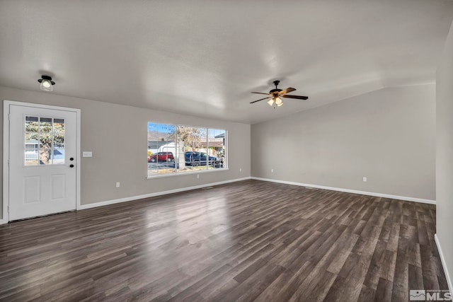 unfurnished living room featuring ceiling fan, dark hardwood / wood-style flooring, lofted ceiling, and a wealth of natural light