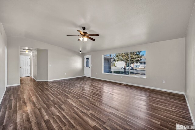 unfurnished living room featuring ceiling fan, dark hardwood / wood-style flooring, and lofted ceiling