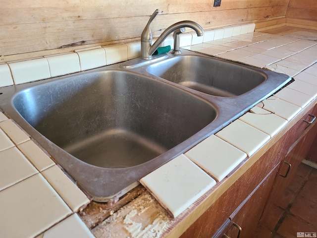 details featuring tile counters and sink