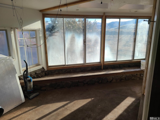 unfurnished sunroom featuring a mountain view