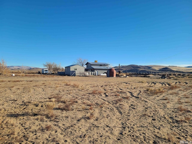 view of yard with a mountain view and a rural view