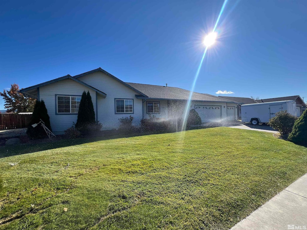 single story home with a front yard and a garage