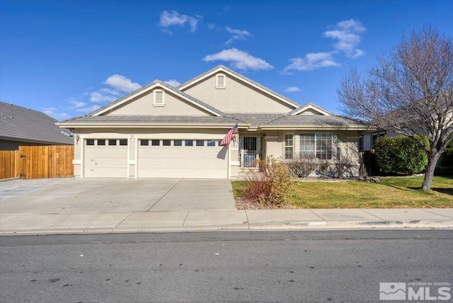 ranch-style house featuring a garage and a front lawn