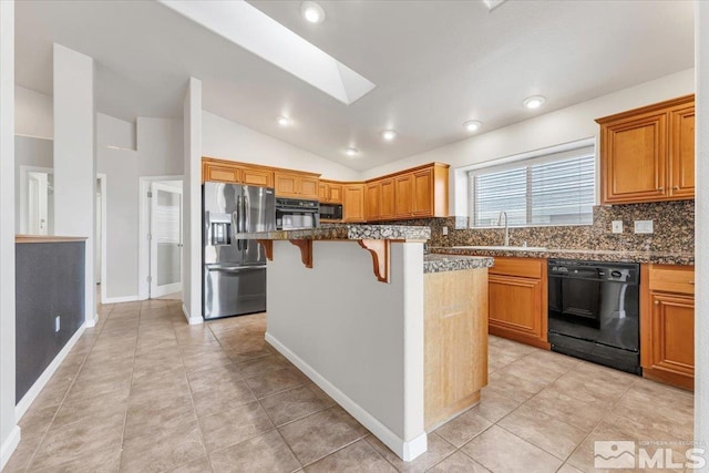 kitchen with a kitchen bar, lofted ceiling with skylight, sink, black appliances, and a center island