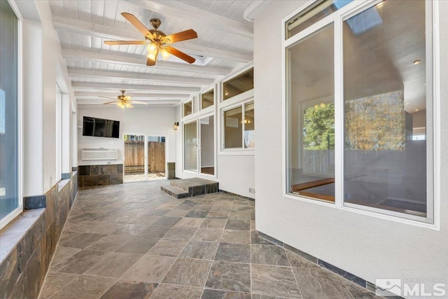 unfurnished sunroom featuring lofted ceiling with beams, ceiling fan, and wooden ceiling