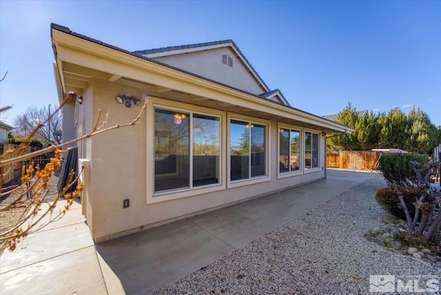 view of property exterior with a patio