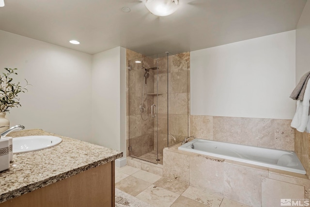 bathroom featuring vanity and independent shower and bath