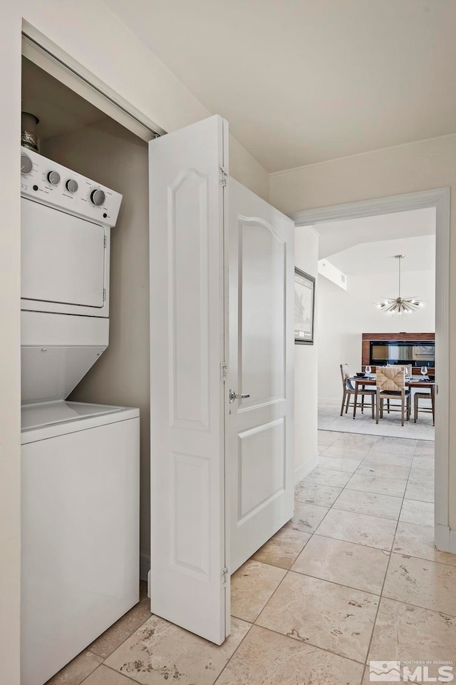 laundry room with stacked washer / dryer