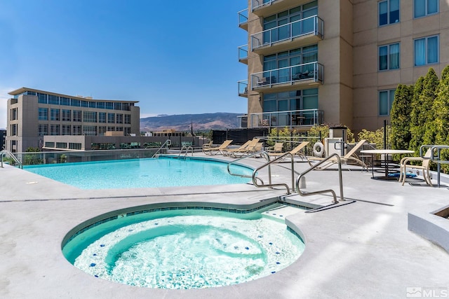 view of pool featuring a patio area and a mountain view