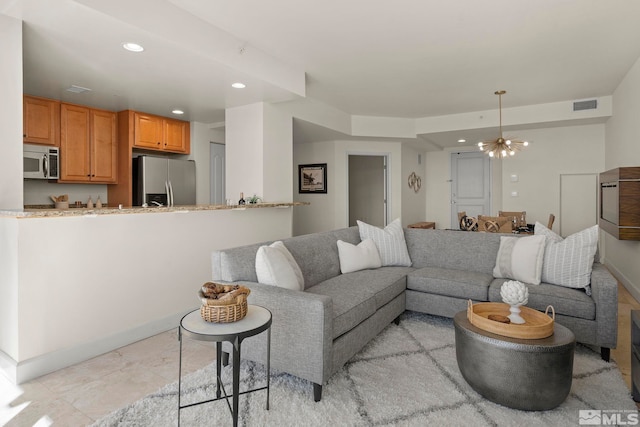 living room featuring light tile patterned floors and an inviting chandelier