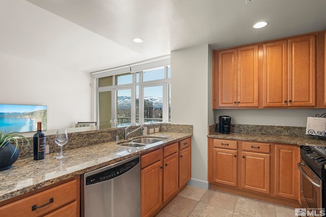 kitchen featuring light tile patterned flooring, sink, stainless steel appliances, and stone counters