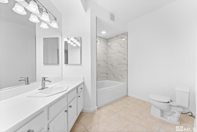 full bathroom featuring tiled shower / bath, tile patterned flooring, vanity, and toilet