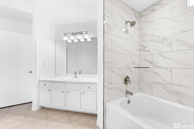 bathroom featuring tile patterned floors, tiled shower / bath combo, and vanity