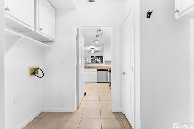 corridor with sink and light tile patterned floors